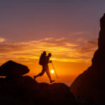 Hiker walking at sunset