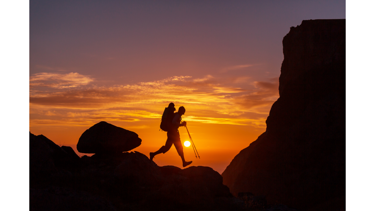 Hiker walking at sunset