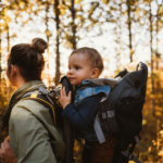 Mother hiking with a baby in baby carrier