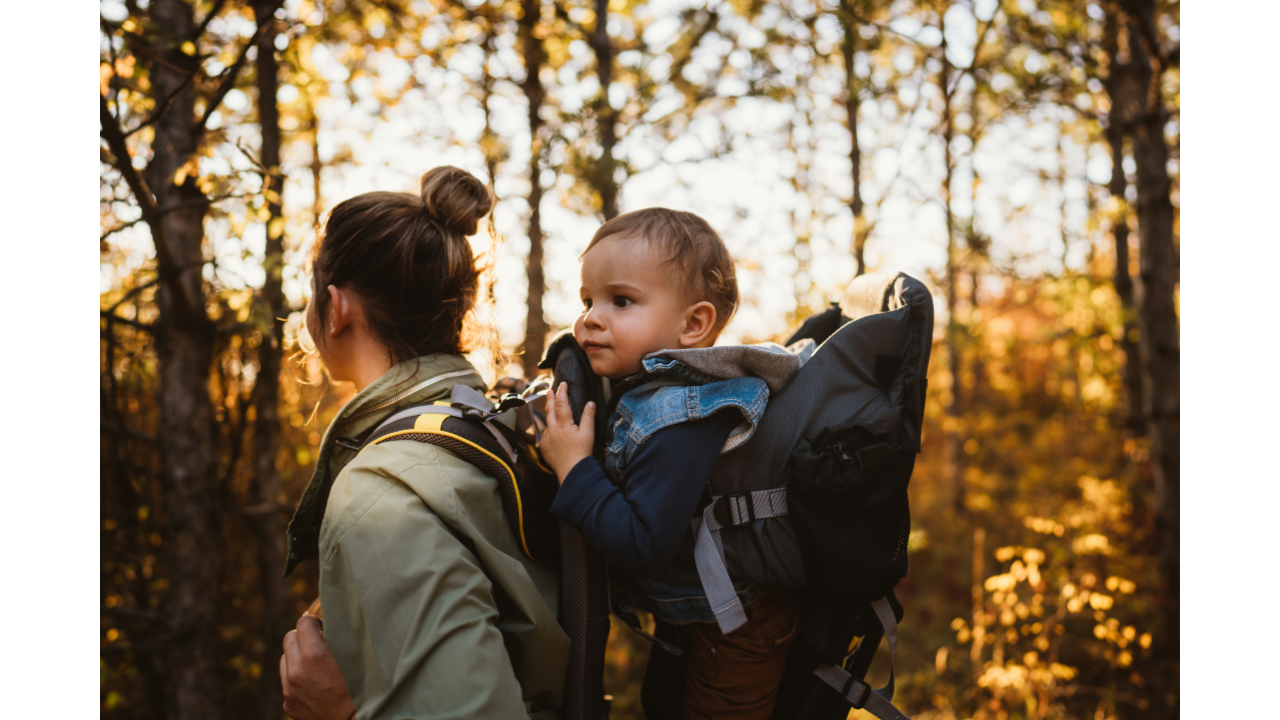 Mother hiking with a baby in baby carrier