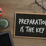 sign saying preparation is the key chalked on it