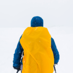 Man carrying a backpack with Waterproof cover