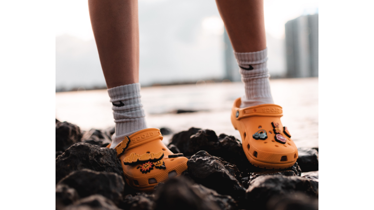 Person wearing orange Crocs
